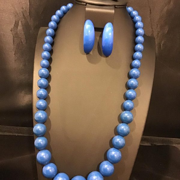 Elevate your ensemble with the "Azure Allure" necklace set, featuring vibrant blue beads and matching oval earrings for a touch of timeless sophistication.