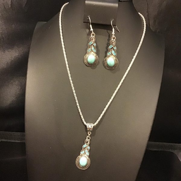 Embrace the serene beauty of the "Aqua Elegance" set, featuring a vintage-style filigree pendant and matching earrings with aquamarine accents that promise to add a touch of timeless sophistication to any ensemble.