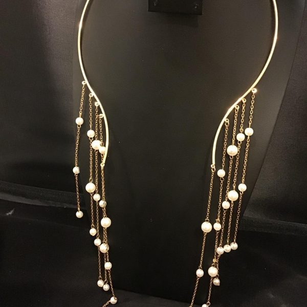 Elevate any outfit with the Golden Cascade Elegance necklace, featuring a gold-tone collar and flowing chains adorned with lustrous pearls. Ideal for evening elegance or daytime chic.