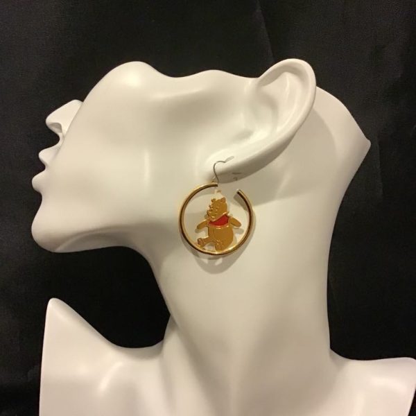 A playful golden hoop earring with a charming bear accent and vibrant red details, perfect for casual chic outfits or quirky statement looks.