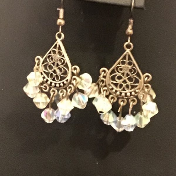 Add a touch of vintage charm with these enchanting chandelier earrings! Featuring intricate filigree work and shimmering crystal-like beads, they bring elegance and movement to any outfit.