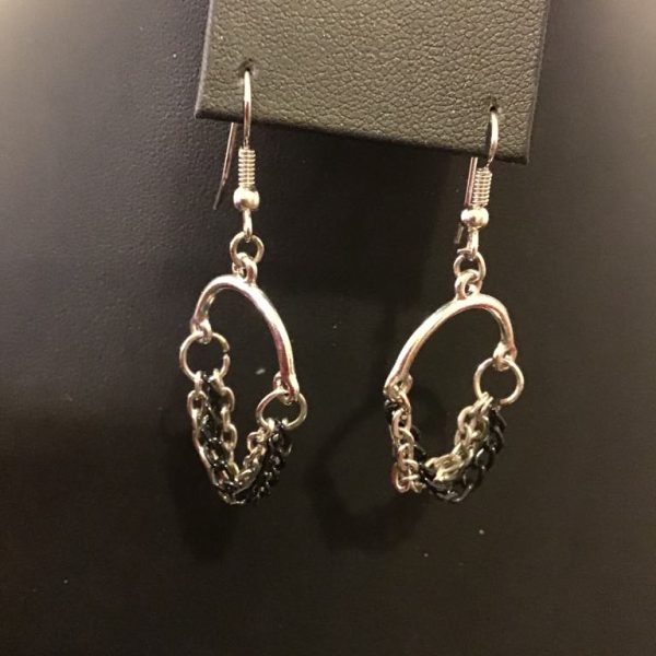 Sleek silver-tone hoop earrings with cascading black and silver chains for an edgy, modern statement look.