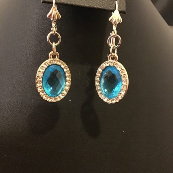 Elegant gold-tone drop earrings featuring faceted blue gemstones encircled by shimmering rhinestones for a timeless, regal look.