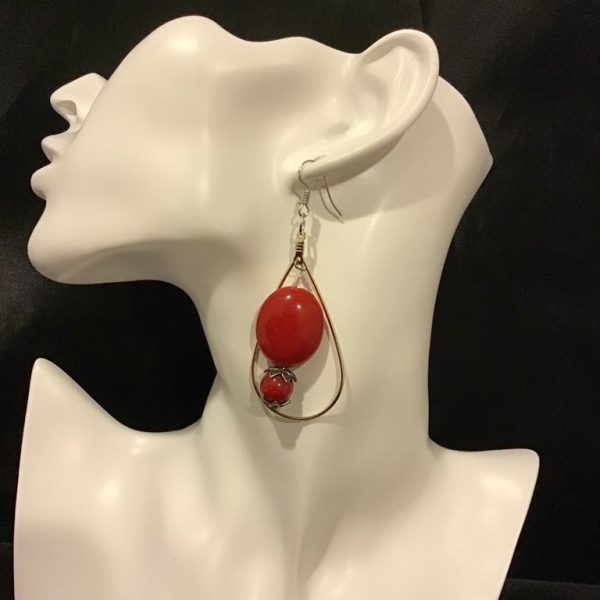 Bold red statement earrings with a teardrop frame, perfect for elevating any outfit with a touch of vintage charm.