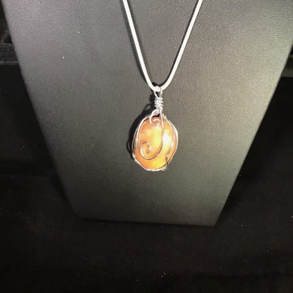 Elevate your look with the Amber Swirl Elegance Necklace, featuring a warm, amber-like stone in a sophisticated silver-tone wire wrap. A stunning piece for any occasion!