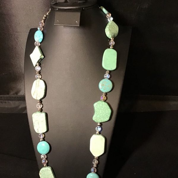 Chunky, sea-toned beads meet shimmering crystals in this bold boho statement necklace—perfect for elevating any outfit with natural charm.