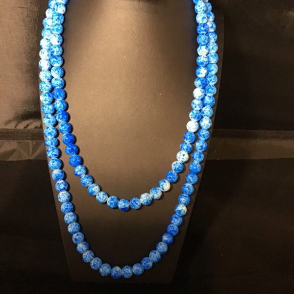 A vibrant double-strand necklace featuring marbled blue and white beads—playful, bold, and ocean-inspired.